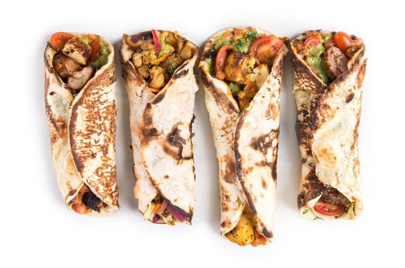 paneer cheese wrap, chicken wrap, vegan wrap and lamb wrap on white background